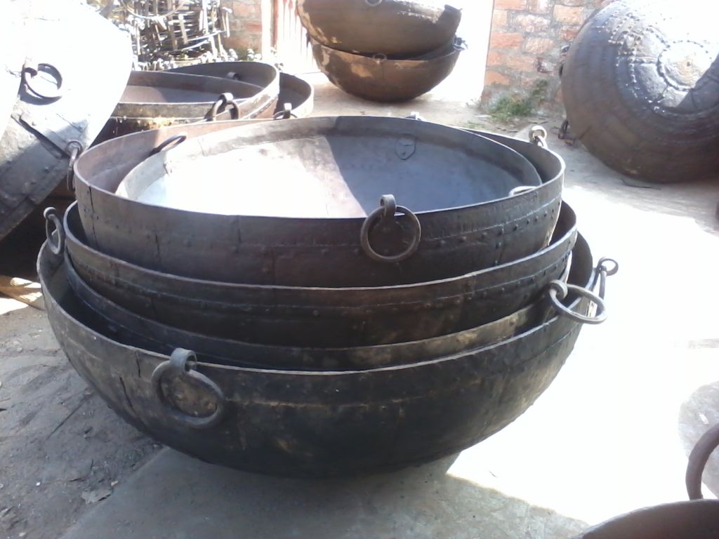 An iron kadai bowl with a fire inside it