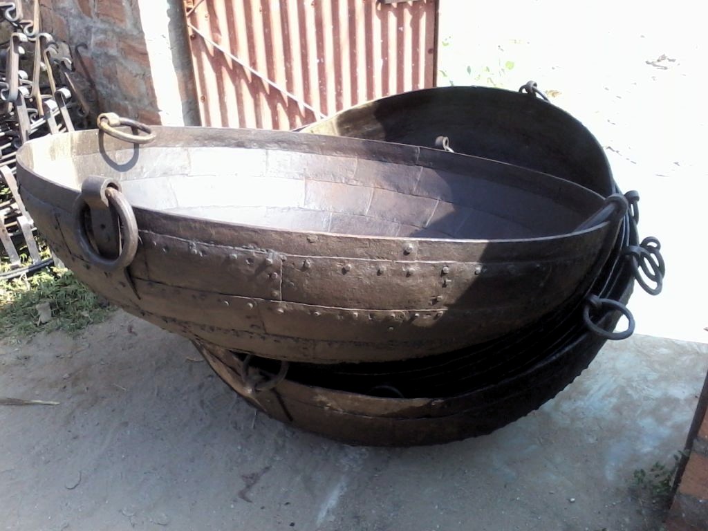 An iron kadai bowl with a fire inside it