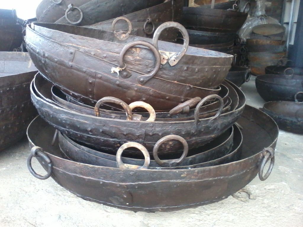 An iron kadai bowl with a fire inside it