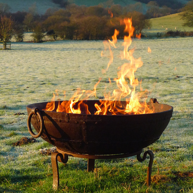 An iron kadai bowl with a fire inside it