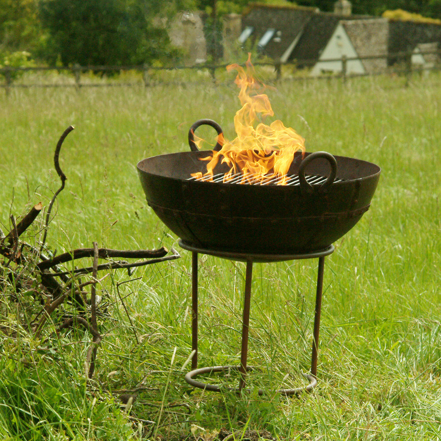 An iron kadai bowl with a fire inside it